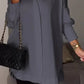 Elegante oversized overhemdblouse met opgerolde mouwen